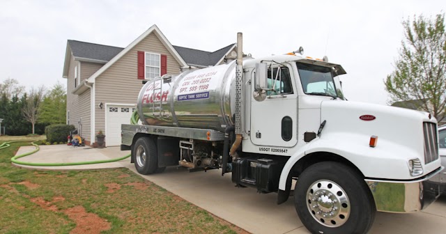 Commercial Septic Pumper Truck Hooked to House Driveway