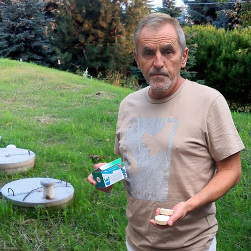 Jason holding Septifix near concrete tank risers
